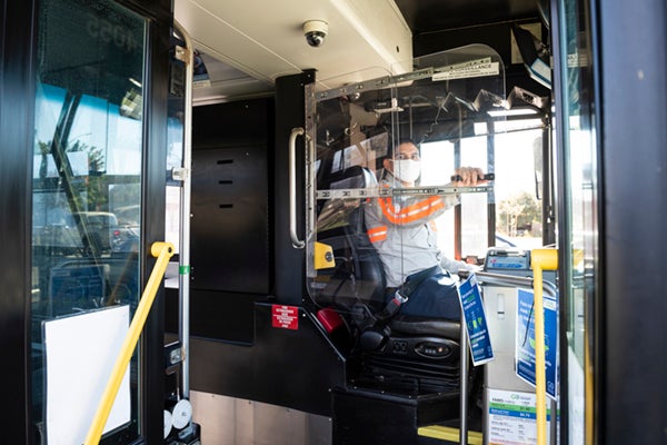 bus operator behind plexiglass