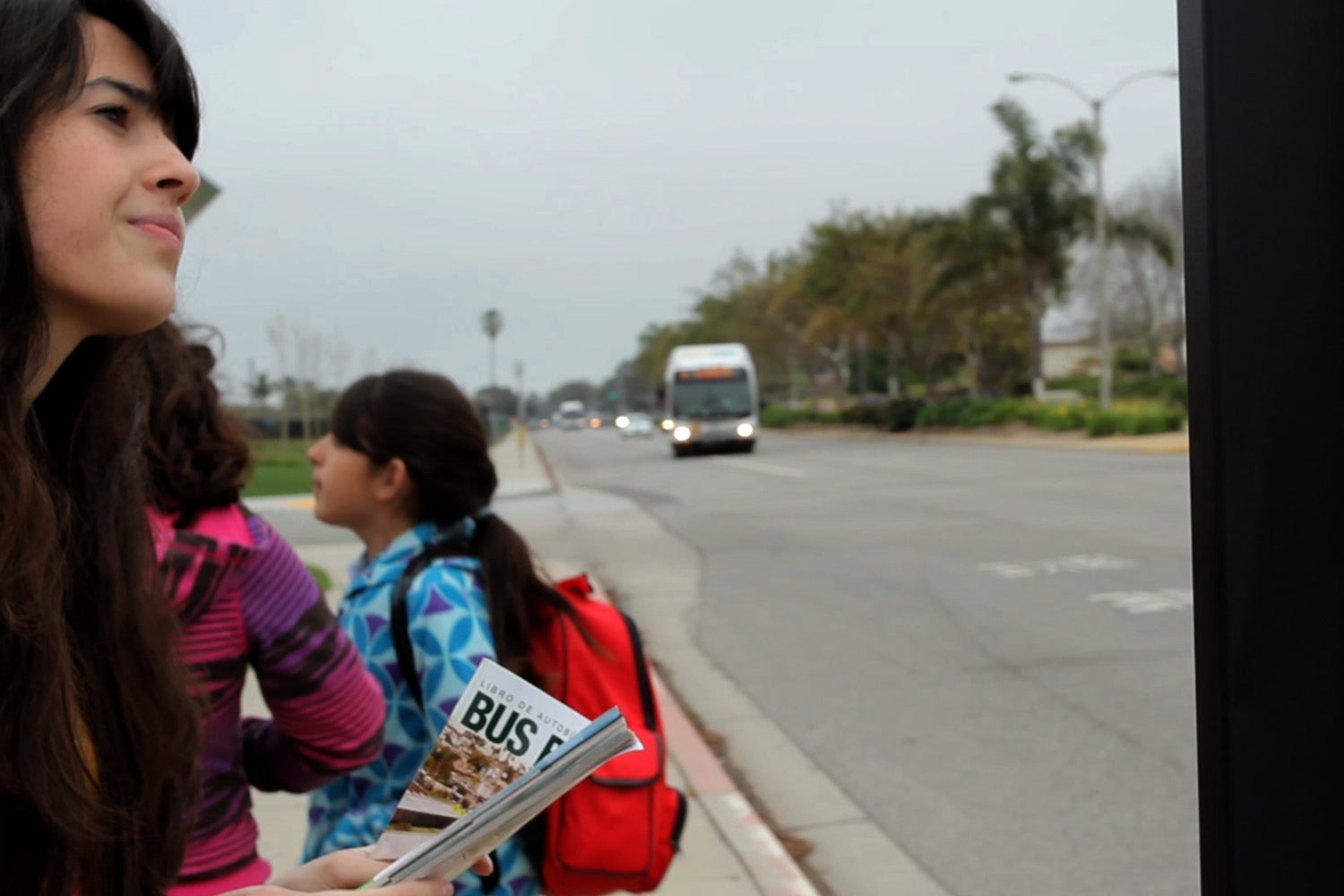 woman at bus stop with child