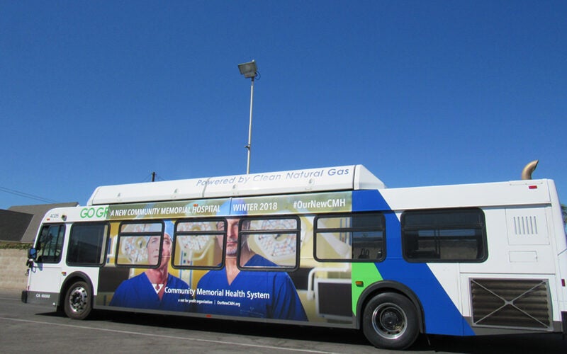 side of bus with ad poster