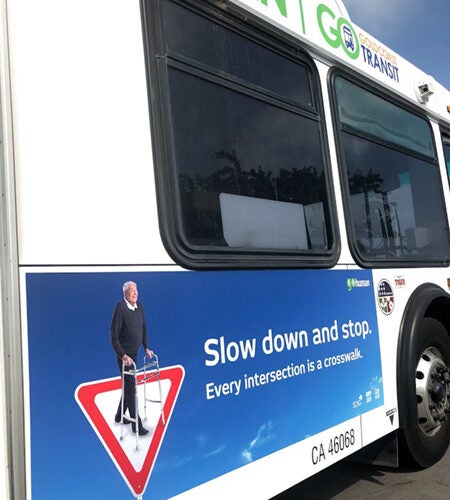 side of bus with ad poster