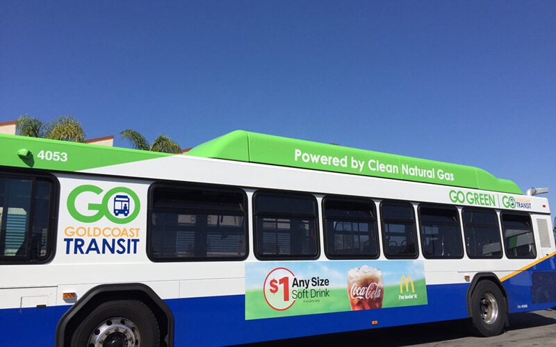 side of bus with ad poster