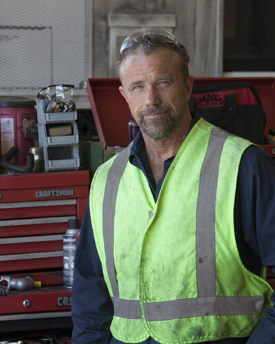 fleet maintenance employee in a construction vest