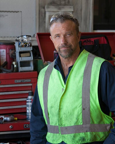 fleet maintenance employee in a construction vest